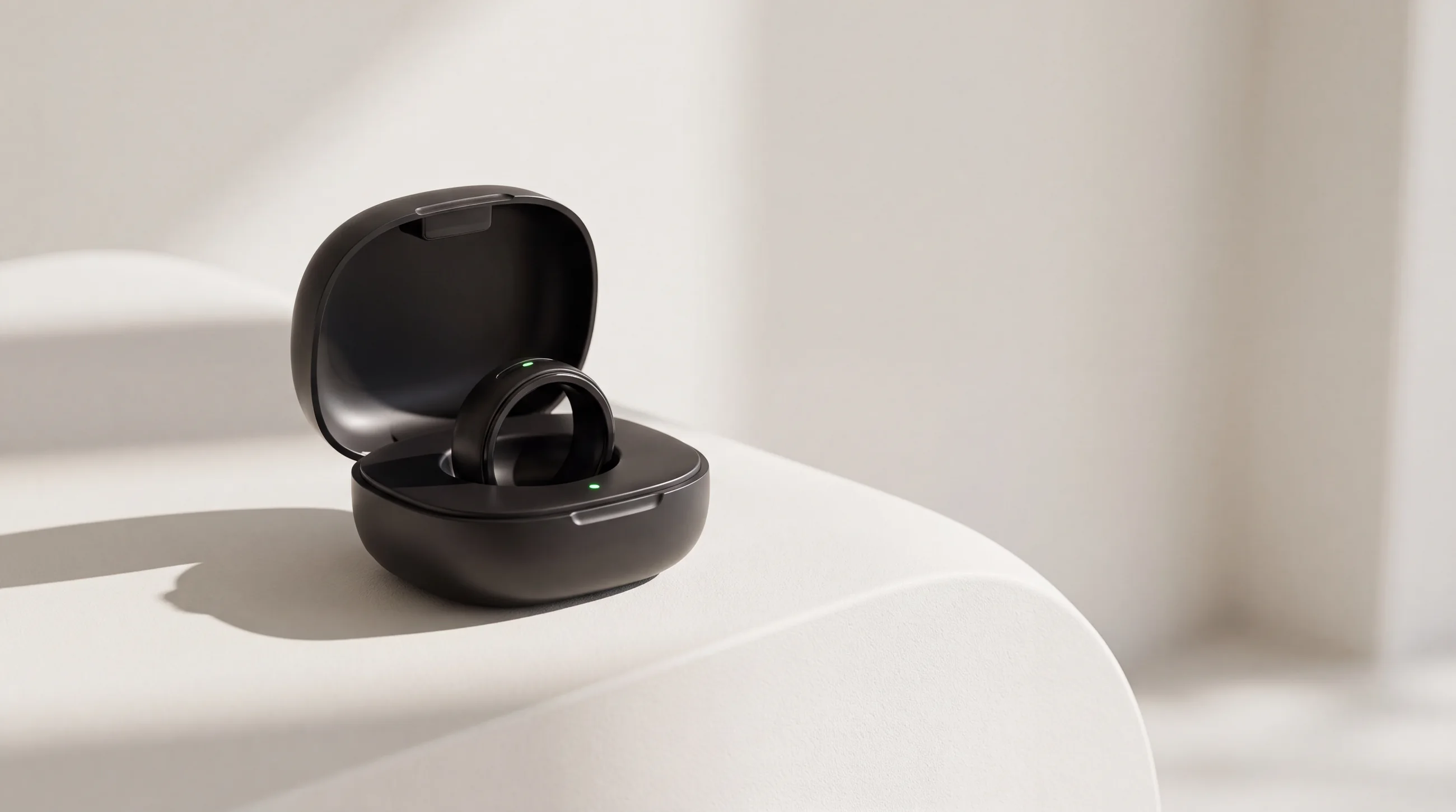 The Zero smart ring resting in its open matte-black charging case